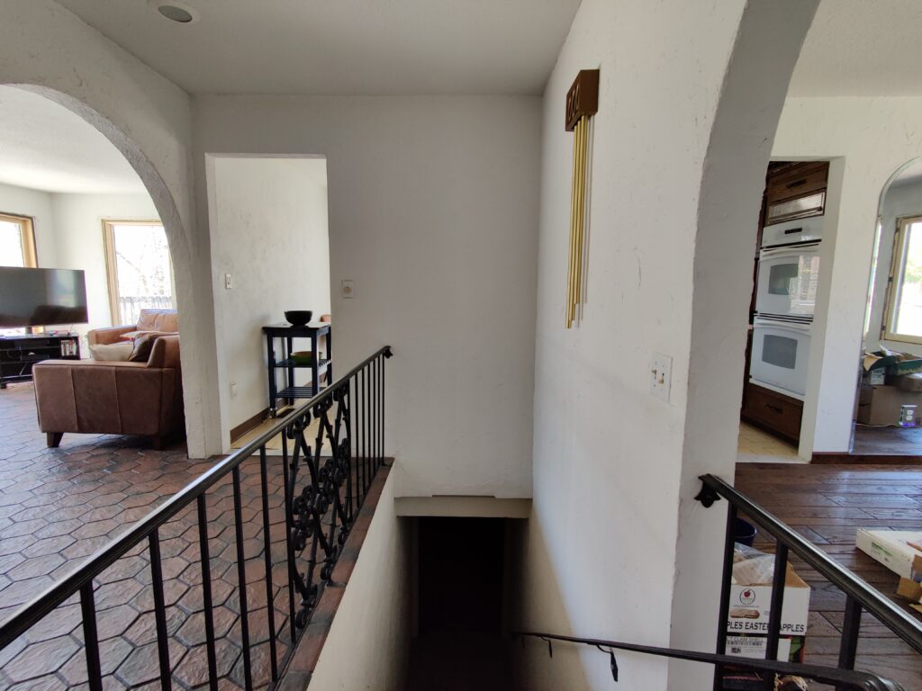View from staircase of living room and kitchen entrances