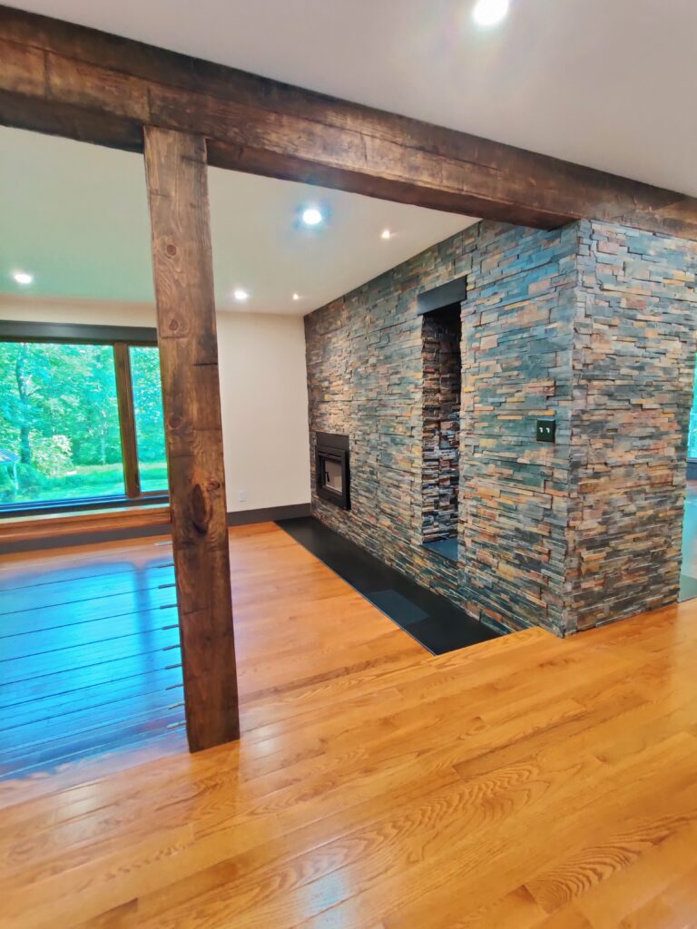 Second living room with fireplace and sunken floor with black granite slab hearth