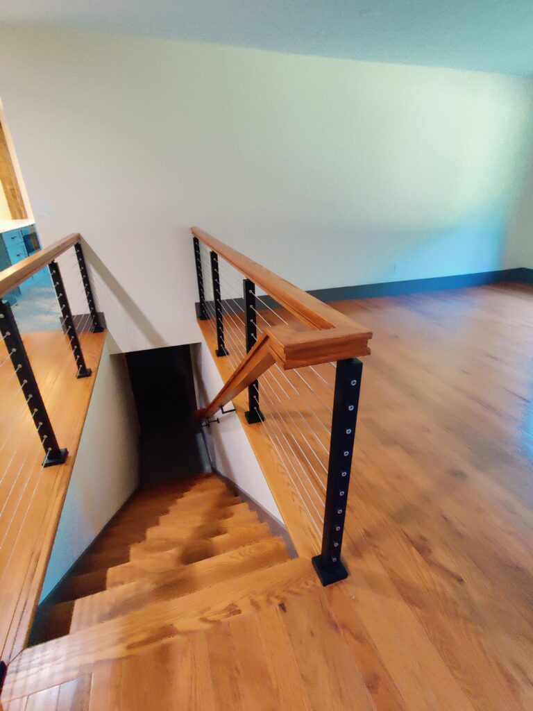Custom stairs with oak rails over red oak flooring